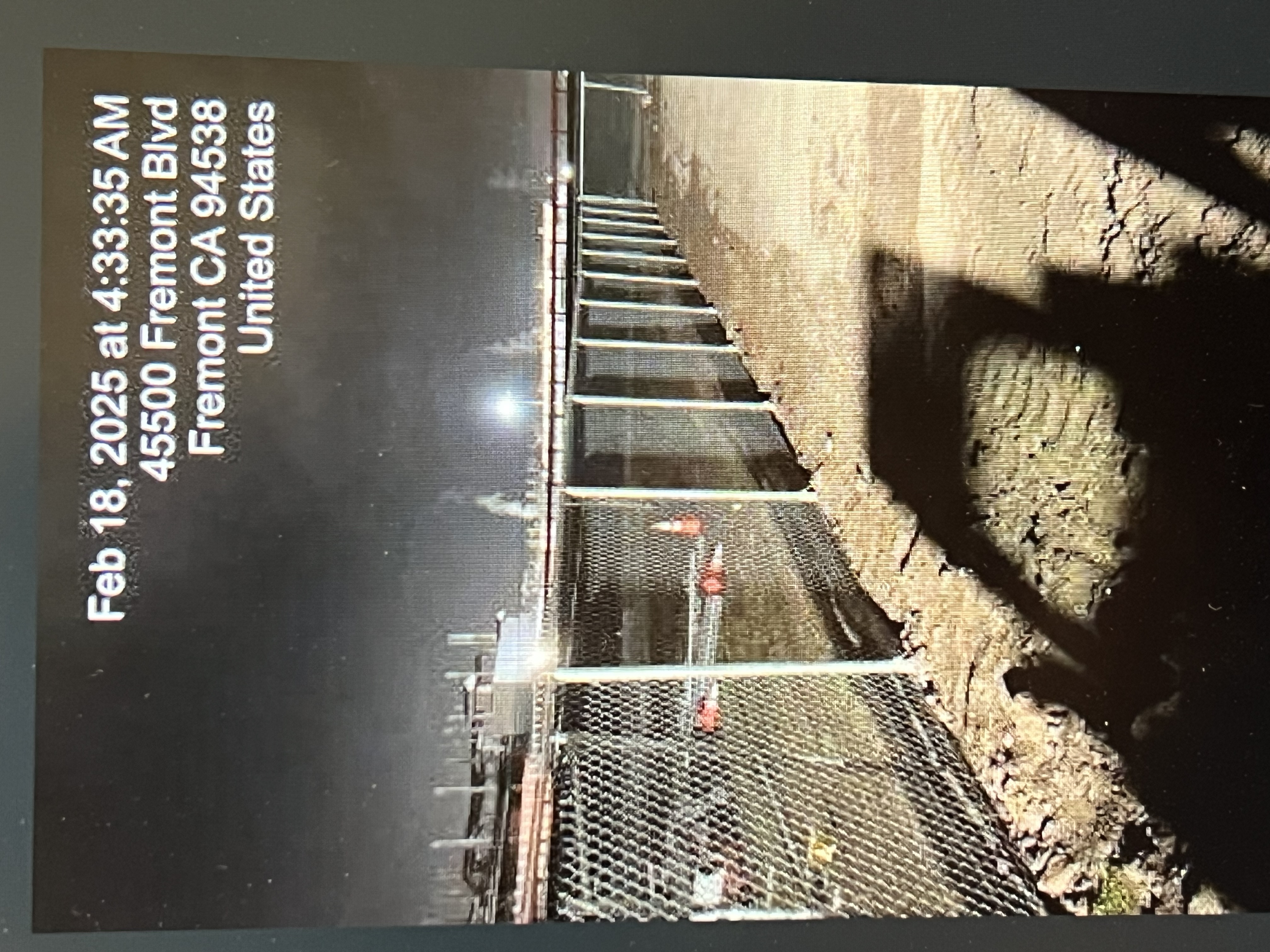 Tesla Fremont telecommunications field leveling and paving work shown at night