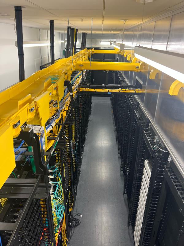 TikTok data center aisle with fiber and low-voltage cabling installation